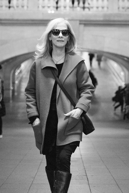 Black and white photo of Susan Weiss Berry walking in Grand Central Station